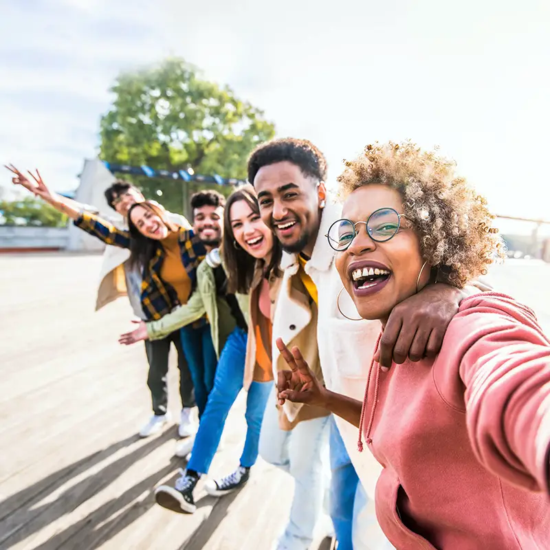 group of people with their arms around each other's shoulders