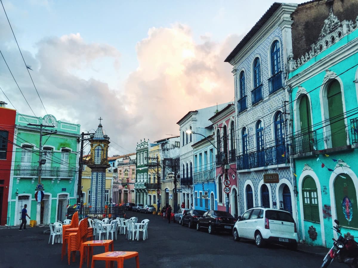 Brazilian street lined with bright green and blue buildings