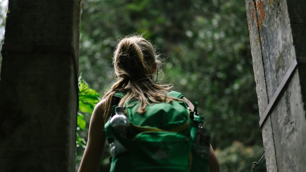 Woman backpacking in the woods