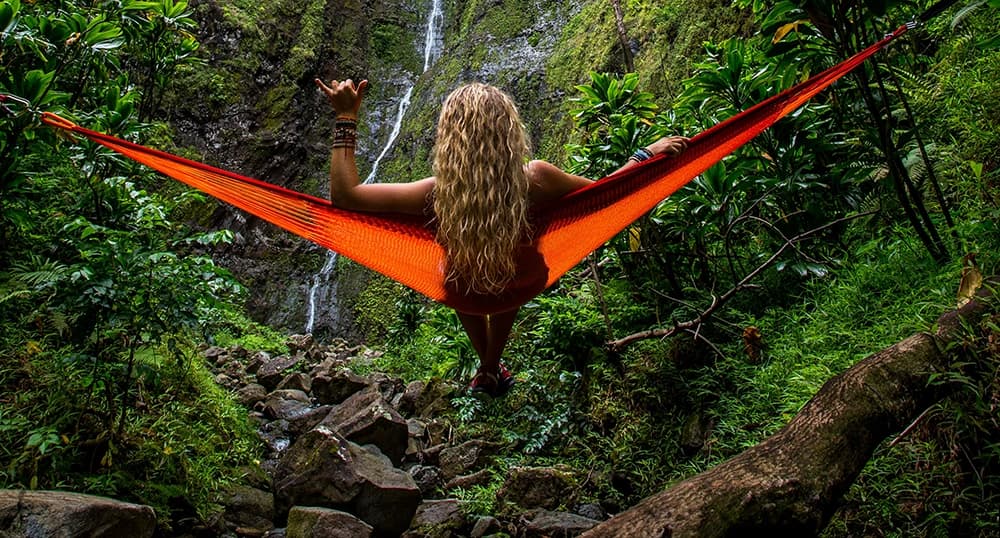 Woman swings in a hammock in the jungle