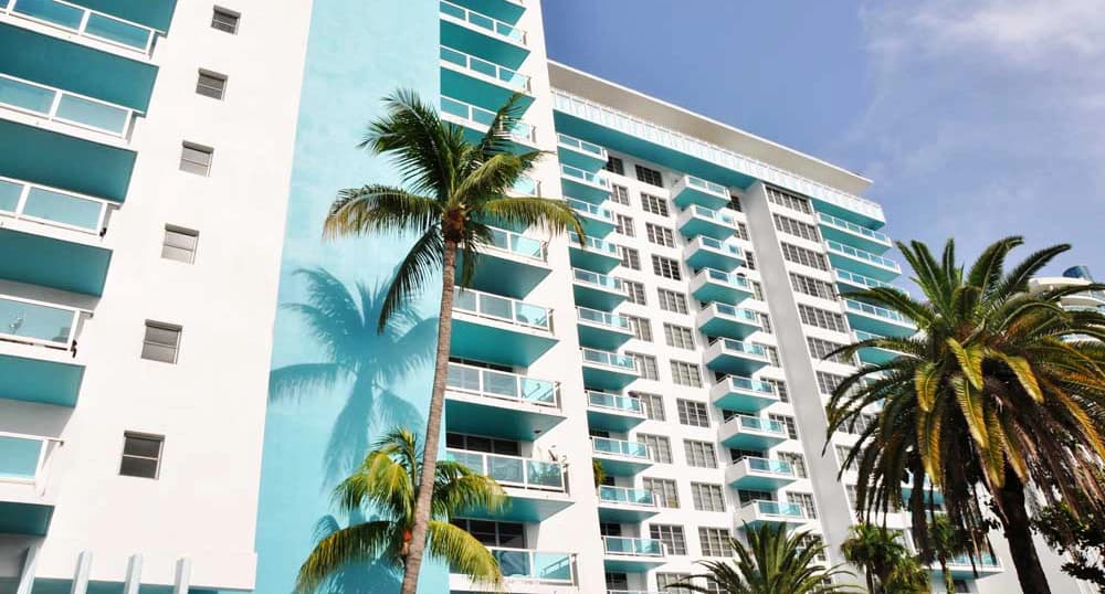 Highrise hotel with palm trees in front