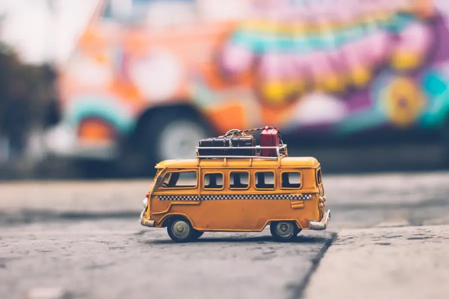 Tiny toy school bus sitting on pavement