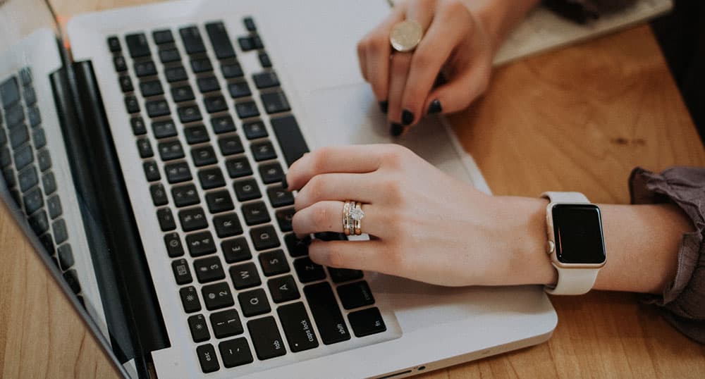 person typing on laptop